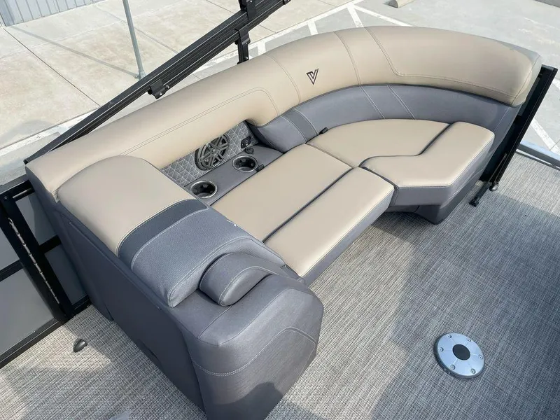 Slide: The Image of 2024 Viaggio Z22S boat seating with beige and gray upholstery, cup holders, and speaker. - 6