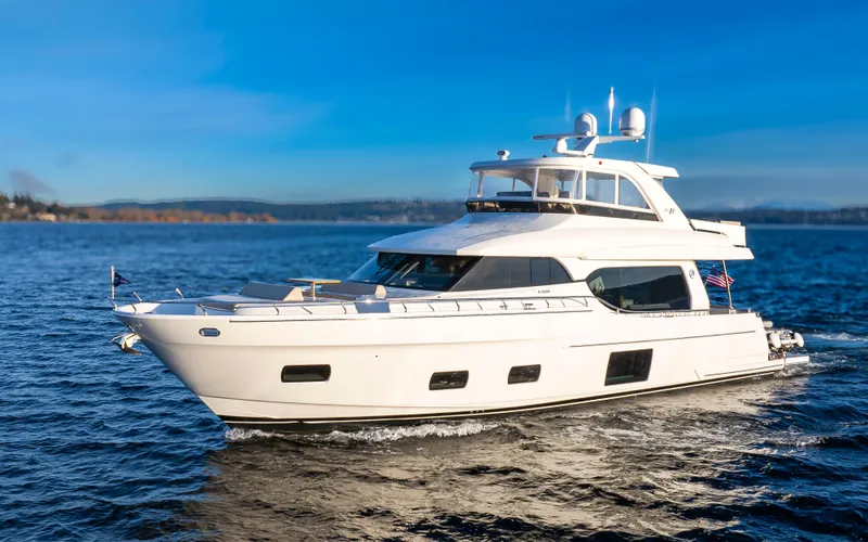 Slide: The Image of 2020 Ocean Alexander 70E Motoryacht cruising on open water under clear blue skies. - 0