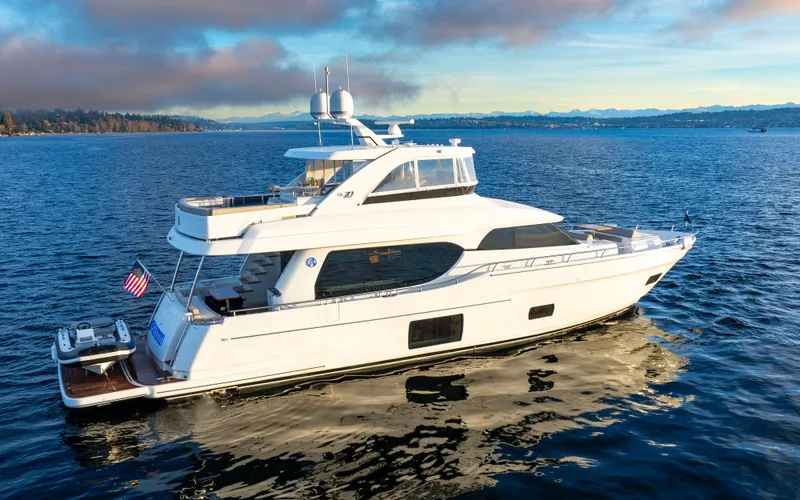 Slide: The Image of 2020 Ocean Alexander 70E Motoryacht cruising on serene waters. - 1