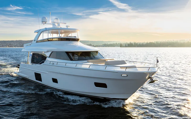 Slide: The Image of 2020 Ocean Alexander 70E Motoryacht cruising on open water at sunset. - 10