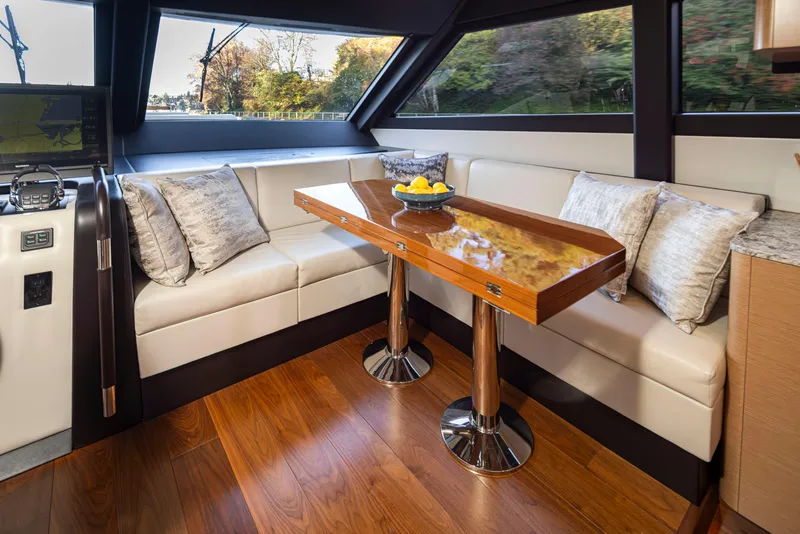 Slide: The Image of Luxurious interior of 2020 Ocean Alexander 70E Motoryacht with elegant seating and wooden table. - 19