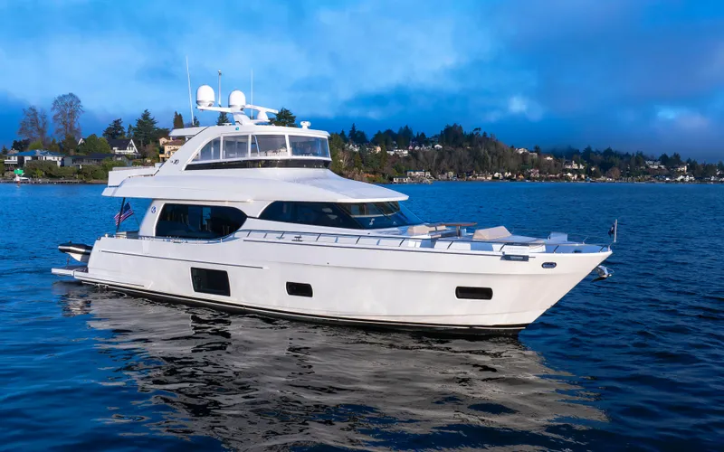 Slide: The Image of 2020 Ocean Alexander 70E Motoryacht cruising on a serene lake. - 2