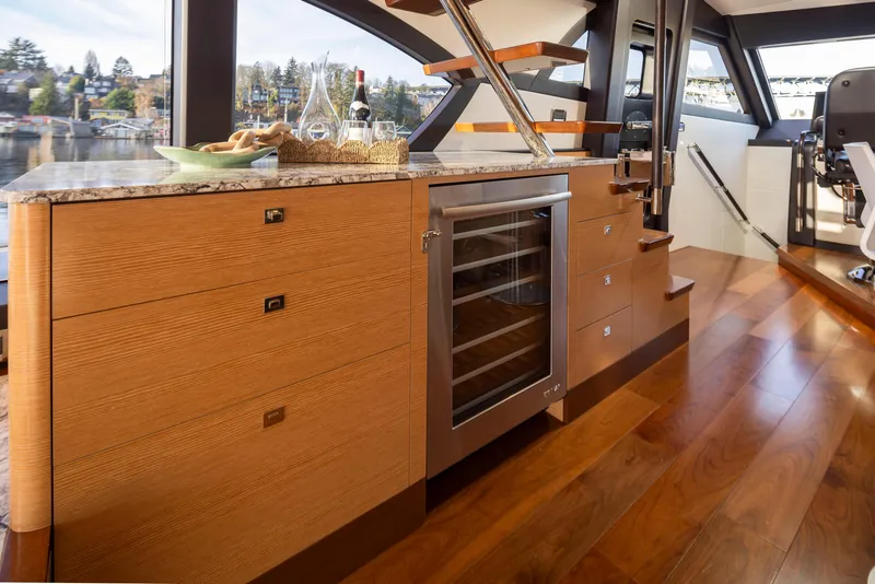 Slide: The Image of Luxurious interior of 2020 Ocean Alexander 70E Motoryacht with wooden cabinetry and wine cooler. - 20