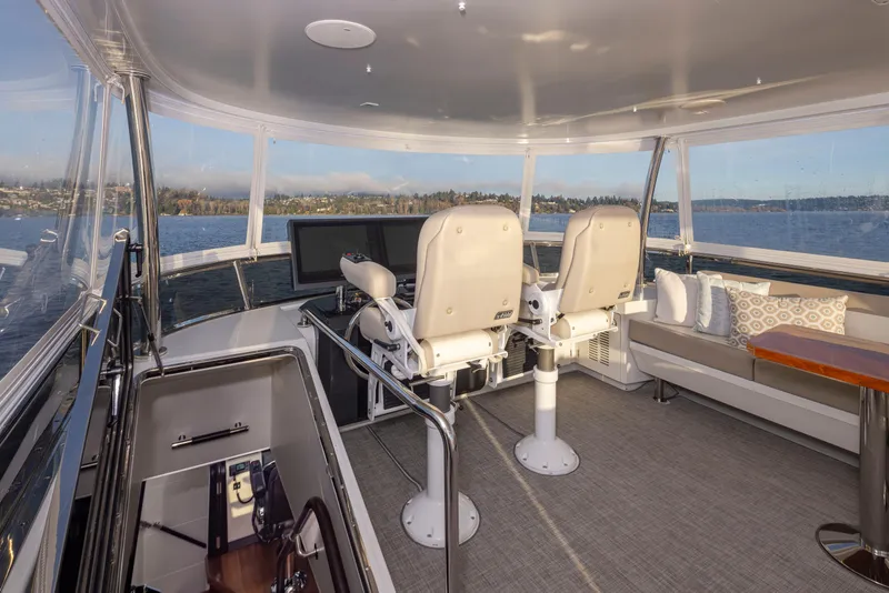 Slide: The Image of Luxurious 2020 Ocean Alexander 70E Motoryacht interior with helm chairs and panoramic windows. - 28