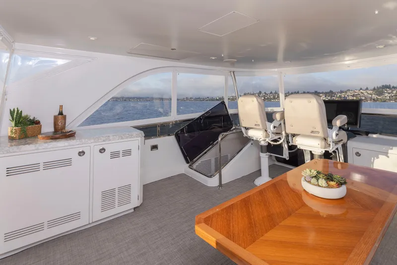 Slide: The Image of Luxurious interior of 2020 Ocean Alexander 70E Motoryacht with elegant seating and wooden table. - 29