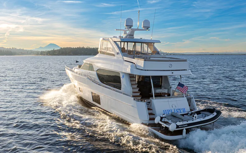 Slide: The Image of 2020 Ocean Alexander 70E Motoryacht cruising on open water at sunset. - 3