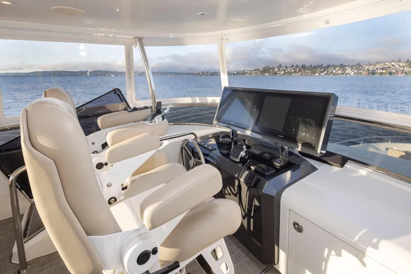 Slide: The Image of Interior helm of 2020 Ocean Alexander 70E Motoryacht with dual captain chairs and navigation screens. - 30