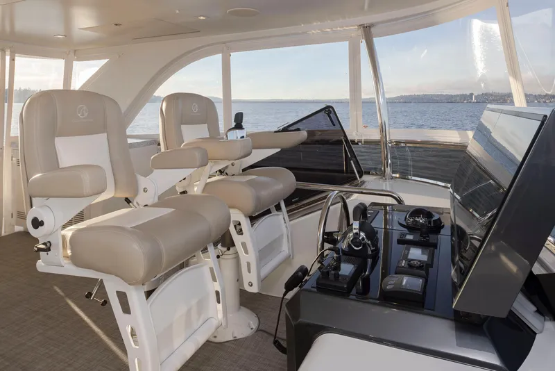 Slide: The Image of Interior of 2020 Ocean Alexander 70E Motoryacht with helm and seating, overlooking the ocean. - 32