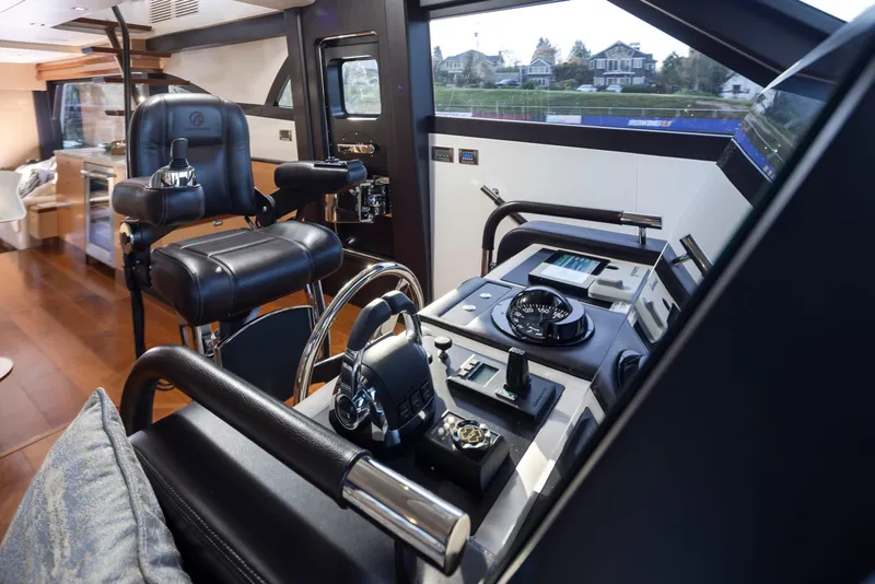 Slide: The Image of Luxurious helm of 2020 Ocean Alexander 70E Motoryacht with modern controls and leather seating. - 38