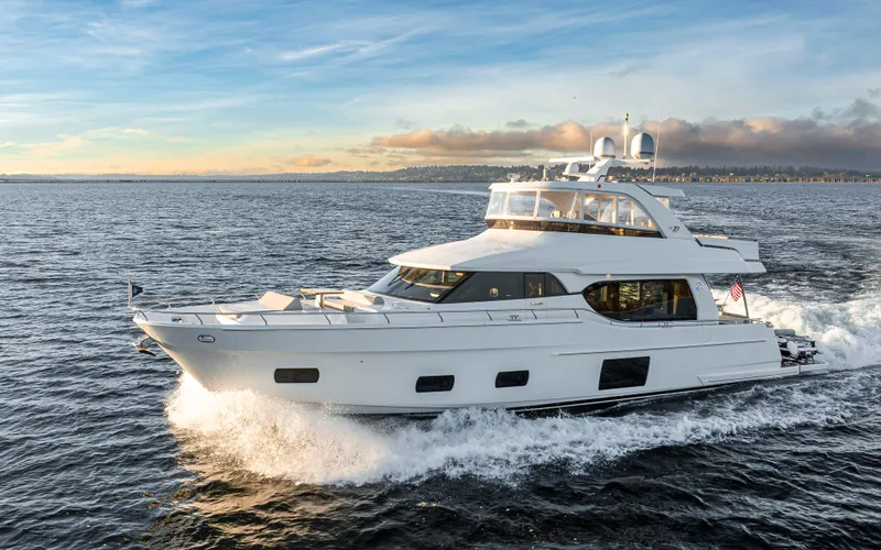Slide: The Image of 2020 Ocean Alexander 70E Motoryacht cruising on open water at sunset. - 4
