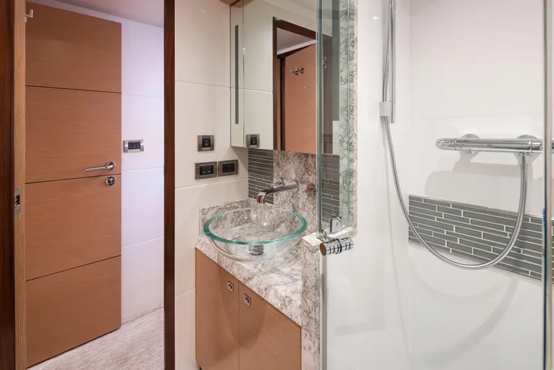 Slide: The Image of Luxurious bathroom in 2020 Ocean Alexander 70E Motoryacht with modern fixtures and glass sink. - 46