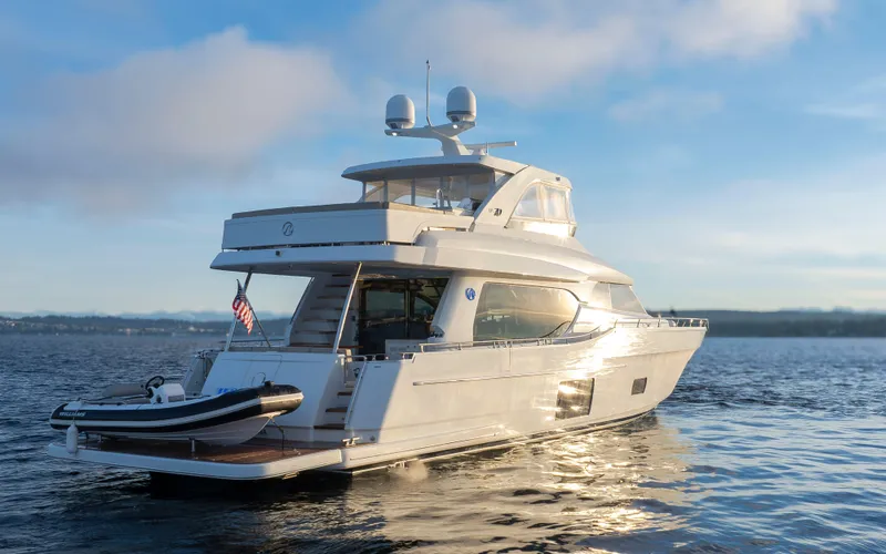 Slide: The Image of 2020 Ocean Alexander 70E Motoryacht cruising on calm waters at sunset. - 5