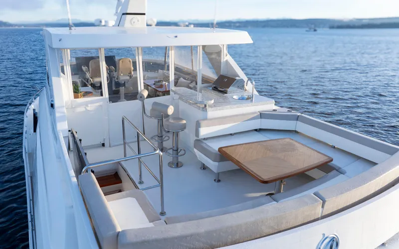 Slide: The Image of 2020 Ocean Alexander 70E Motoryacht with spacious deck and seating area on the water. - 6