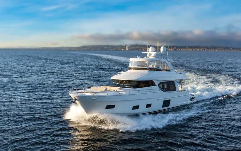 Slide: The Image of 2020 Ocean Alexander 70E Motoryacht cruising on open water under a clear sky. - 7