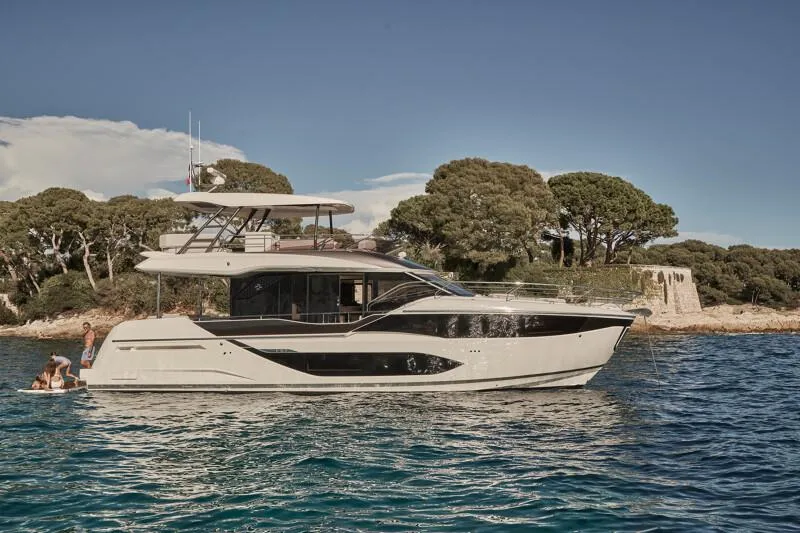 Slide: The Image of Luxury Prestige F5.7 yacht cruising near scenic coastline, 2026 model. - 1