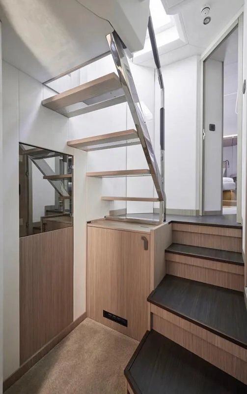 Slide: The Image of Modern interior staircase in 2026 Prestige F5.7 yacht, featuring sleek design and wood accents. - 22