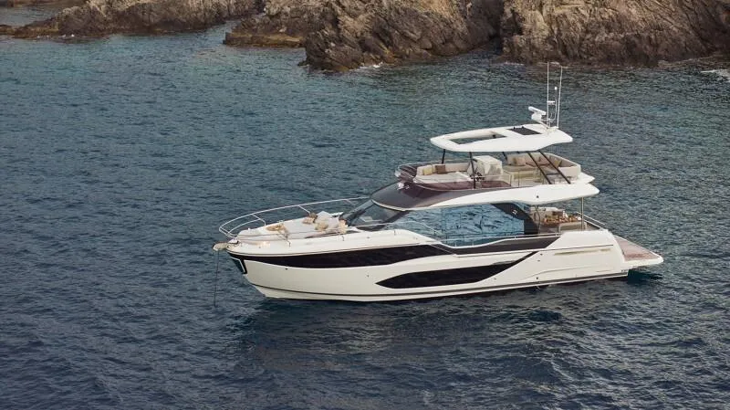 Slide: The Image of Luxury Prestige F5.7 yacht cruising near rocky coastline, 2026 model. - 3