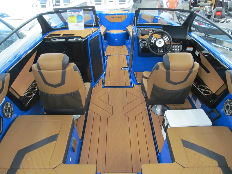 Slide: The Image of 2025 Yamaha Boats 222XD interior with tan and black seating, blue accents, and modern dashboard. - 4