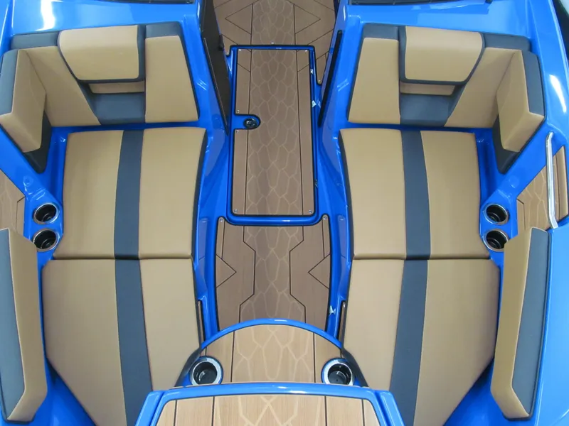 Slide: The Image of 2025 Yamaha Boats 222XD interior with blue and tan seating, stylish design, and wood accents. - 8