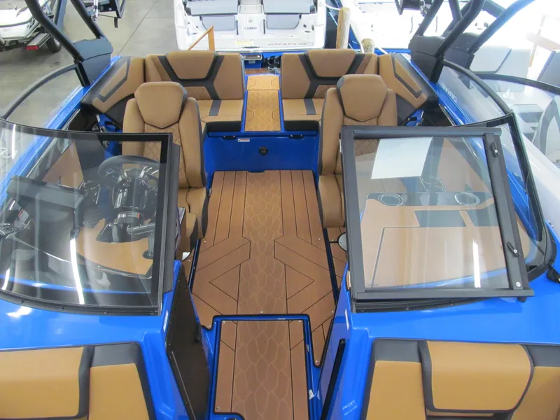 Slide: The Image of 2025 Yamaha Boats 222XD interior with brown seating and blue accents. - 9