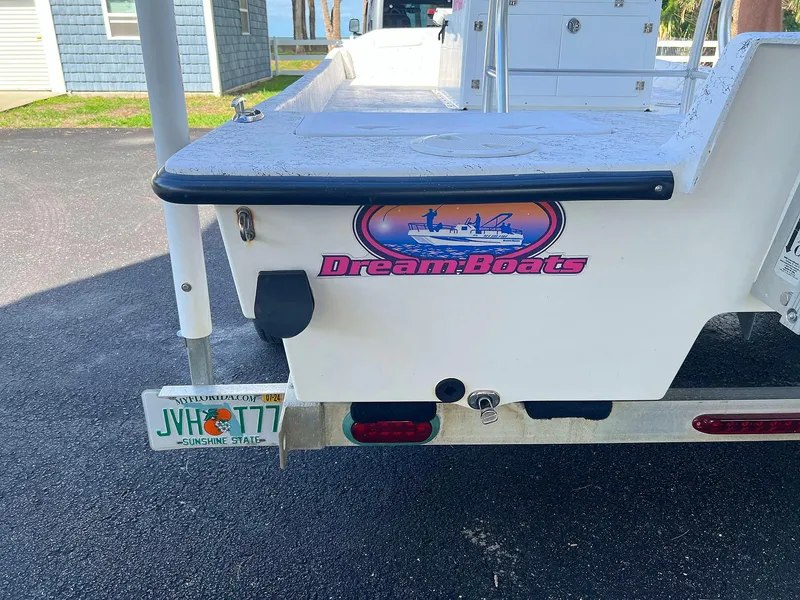 Slide: The Image of 2013 Dream Boats C-18 with Florida license plate, parked on asphalt. - 10