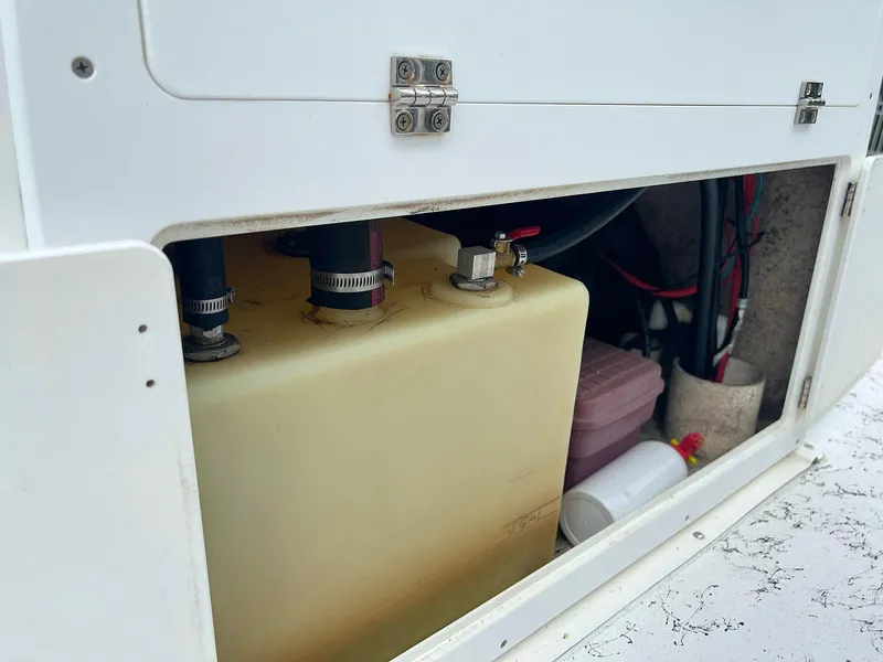 Slide: The Image of 2013 Dream Boats C-18 storage compartment with fuel tank and accessories. - 14