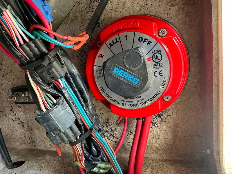 Slide: The Image of Red Perko marine battery switch with colorful wiring in a 2013 Dream Boats C-18. - 15