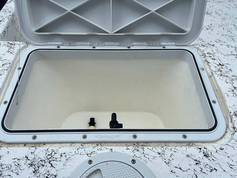 Slide: The Image of Open storage compartment on 2013 Dream Boats C-18 model. - 19