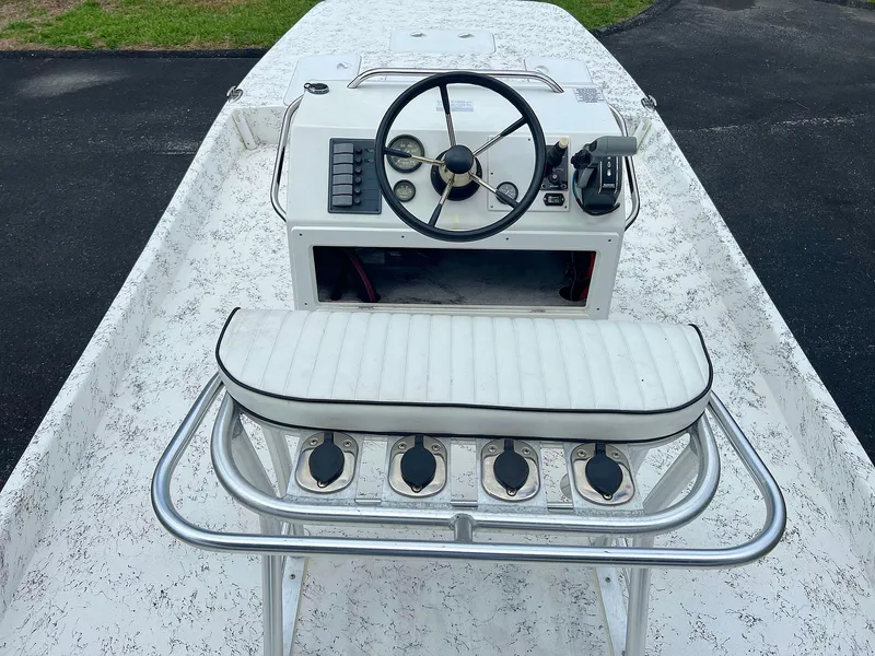 Slide: The Image of 2013 Dream Boats C-18 console with steering wheel and cushioned seat. - 2