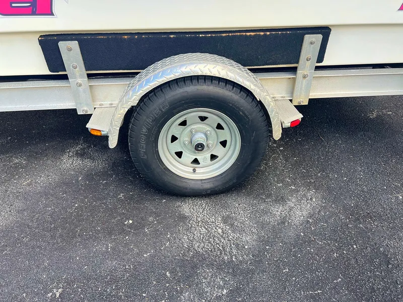 Slide: The Image of Trailer wheel of 2013 Dream Boats C-18 on asphalt surface. - 23