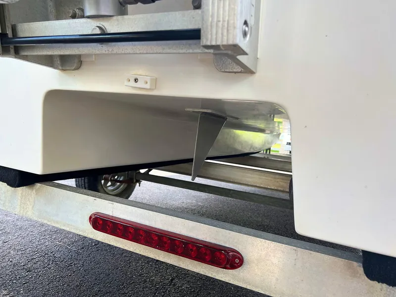 Slide: The Image of Close-up of 2013 Dream Boats C-18 hull on trailer with red reflector. - 24
