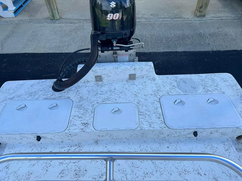 Slide: The Image of 2013 Dream Boats C-18 with Suzuki 90 engine, featuring storage compartments. - 28