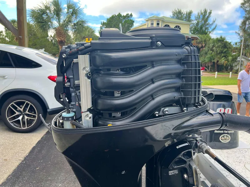 Slide: The Image of Close-up of a 2013 Dream Boats C-18 engine, parked near a white SUV. - 8