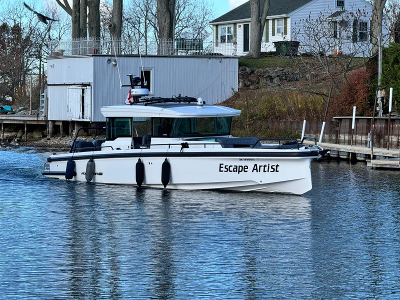 The Image of Axopar 37 Cross Cabin BRABUS 2020 docked, sunny day, calm water, "Escape Artist" on side. - 0