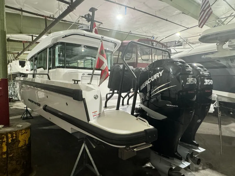 Slide: The Image of 2020 Axopar 37 Cross Cabin BRABUS boat side view in a garage. - 19