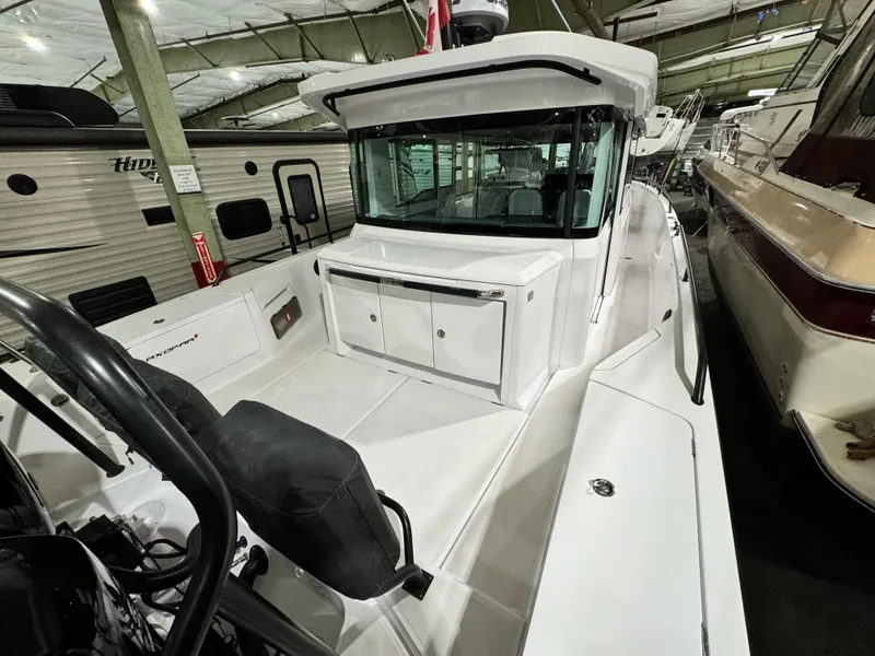 Slide: The Image of Three gray cushioned seats on a 2020 Axopar 37 Cross Cabin BRABUS boat. - 24
