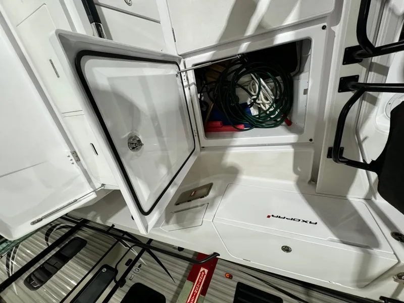 Slide: The Image of Storage compartment with hose and equipment on 2020 Axopar 37 Cross Cabin BRABUS. - 38