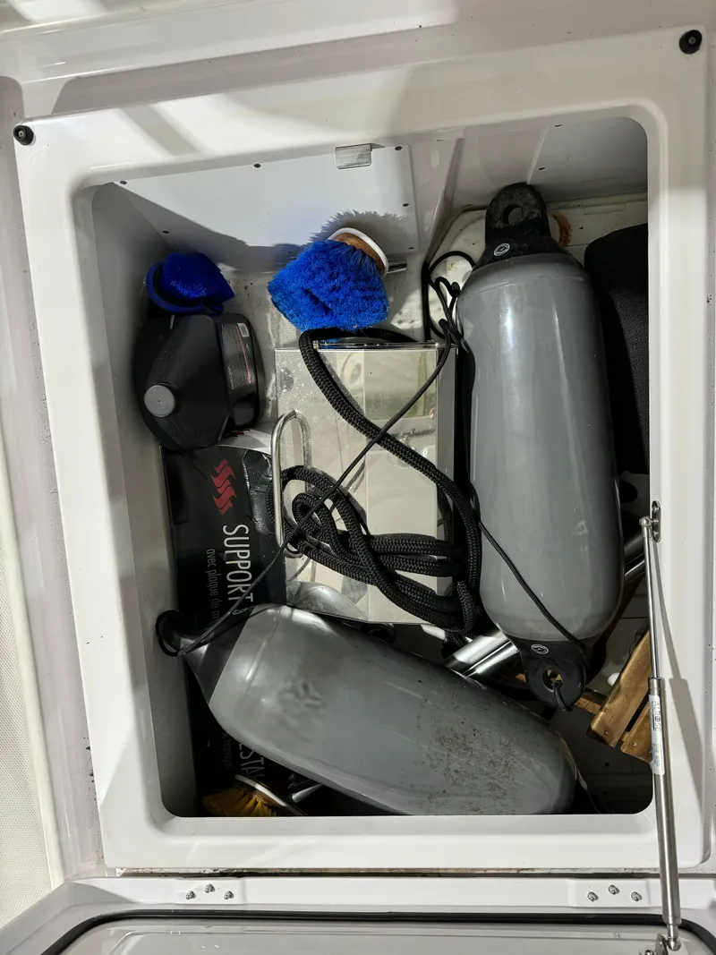 Slide: The Image of Storage compartments on a 2020 Axopar 37 Cross Cabin BRABUS, containing various boating equipment. - 40