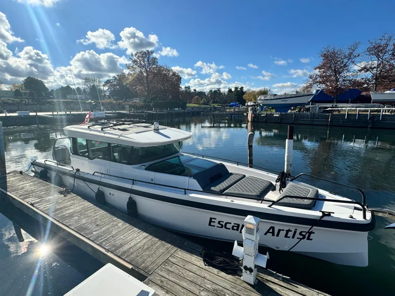 Slide: The Image of 2020 Axopar 37 Cross Cabin BRABUS boat docked on a sunny day with clouds. - 5