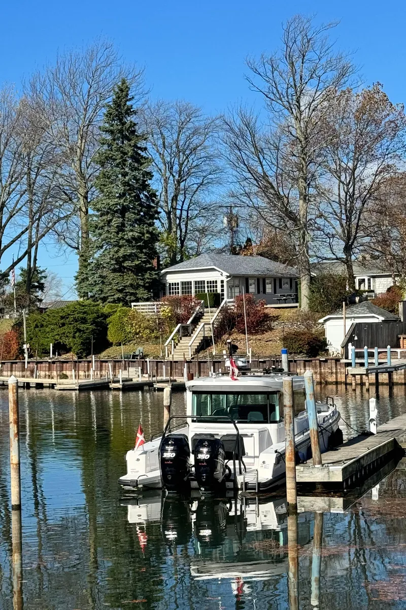 Slide: The Image of 2020 Axopar 37 Cross Cabin BRABUS boat named "Escape Artist" in indoor storage. - 8