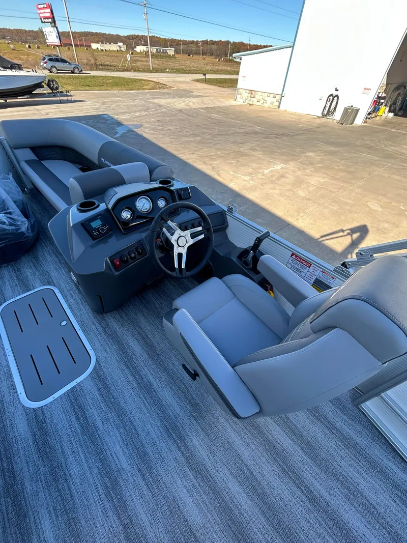 Slide: The Image of 2025 Bennington S 22 pontoon boat interior with modern dashboard and seating. - 6