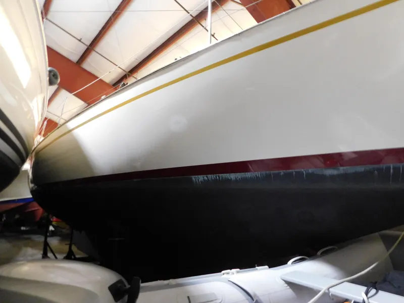 The Image of 1949 Burger Full Keel Steel Auxiliary Ketch in storage, showcasing sleek hull design. - 1