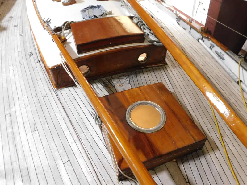 Slide: The Image of 1949 Burger Full Keel Steel Auxiliary Ketch deck with wooden details and portholes. - 13