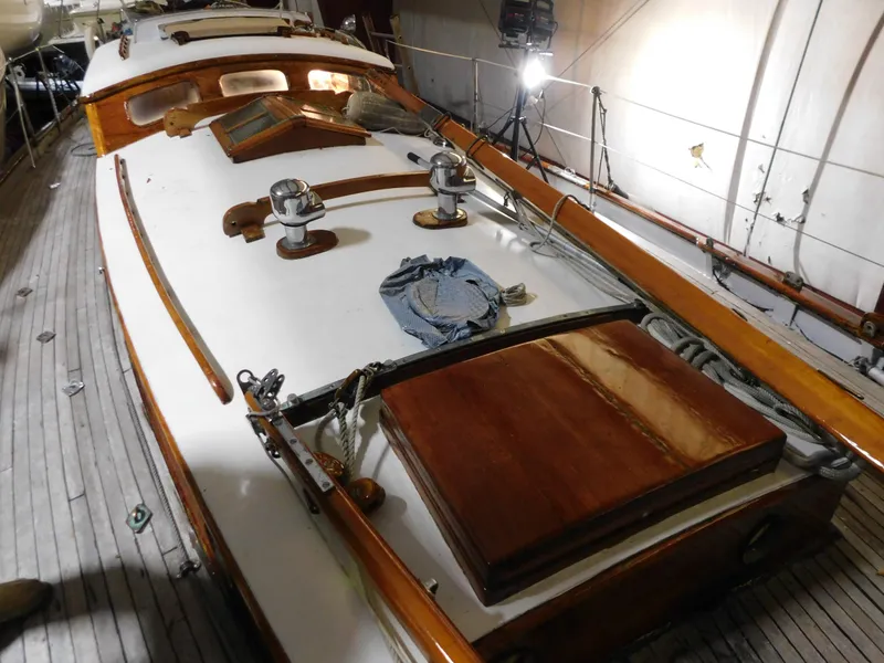 Slide: The Image of 1949 Burger Full Keel Steel Auxiliary Ketch deck with wooden details and nautical equipment. - 14