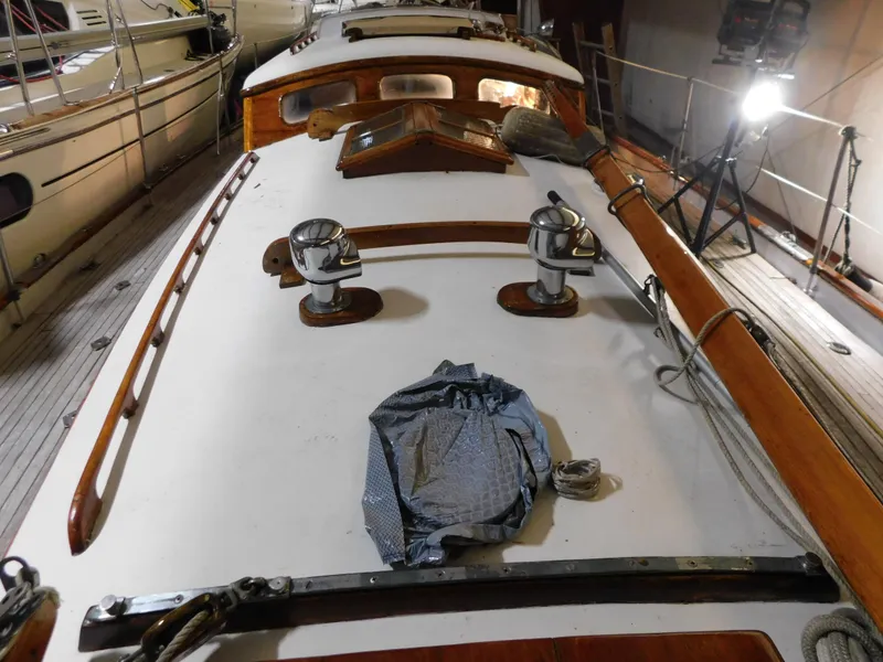 Slide: The Image of 1949 Burger Full Keel Steel Auxiliary Ketch deck with winches and wooden details. - 15