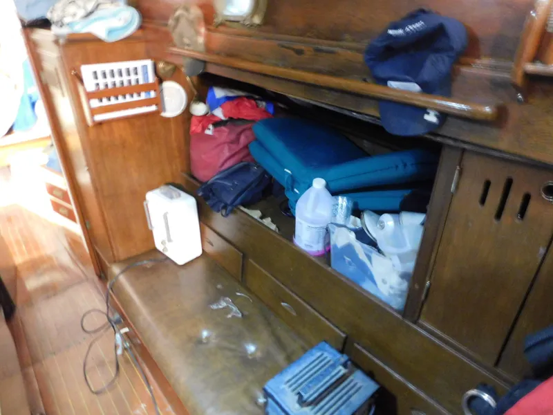 Slide: The Image of Interior of a 1949 Burger Full Keel Steel Auxiliary Ketch with storage and nautical equipment. - 26