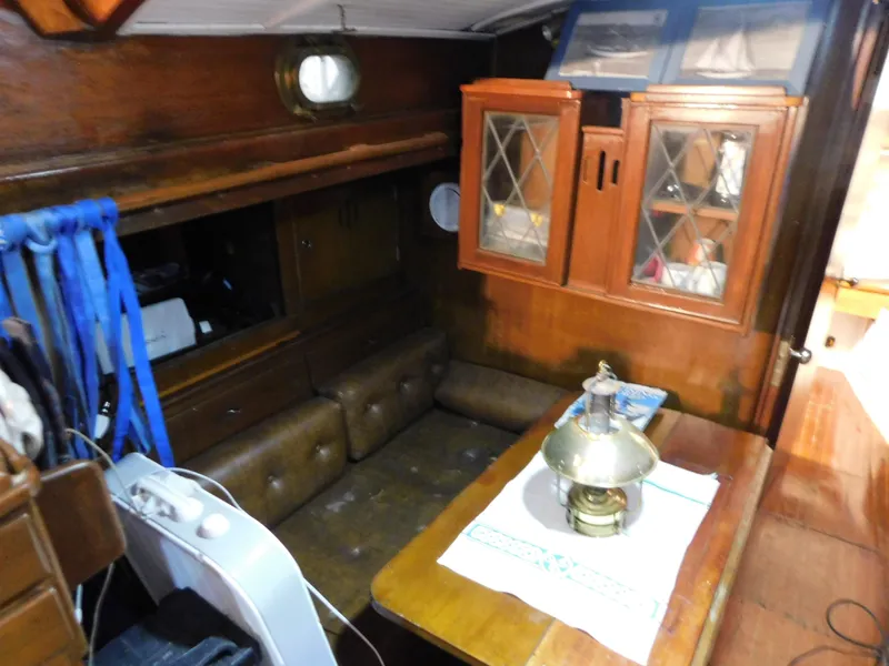 Slide: The Image of Interior of 1949 Burger Full Keel Steel Auxiliary Ketch with wooden cabinets and seating area. - 27