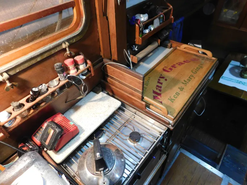Slide: The Image of Interior of 1949 Burger Full Keel Steel Auxiliary Ketch with kitchen essentials and wooden cabinetry. - 30