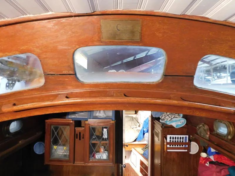 Slide: The Image of Interior of 1949 Burger Full Keel Steel Auxiliary Ketch with wooden cabinetry and portholes. - 33