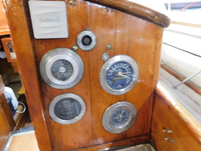 Slide: The Image of Wooden dashboard with nautical gauges on a 1949 Burger Full Keel Steel Auxiliary Ketch. - 34